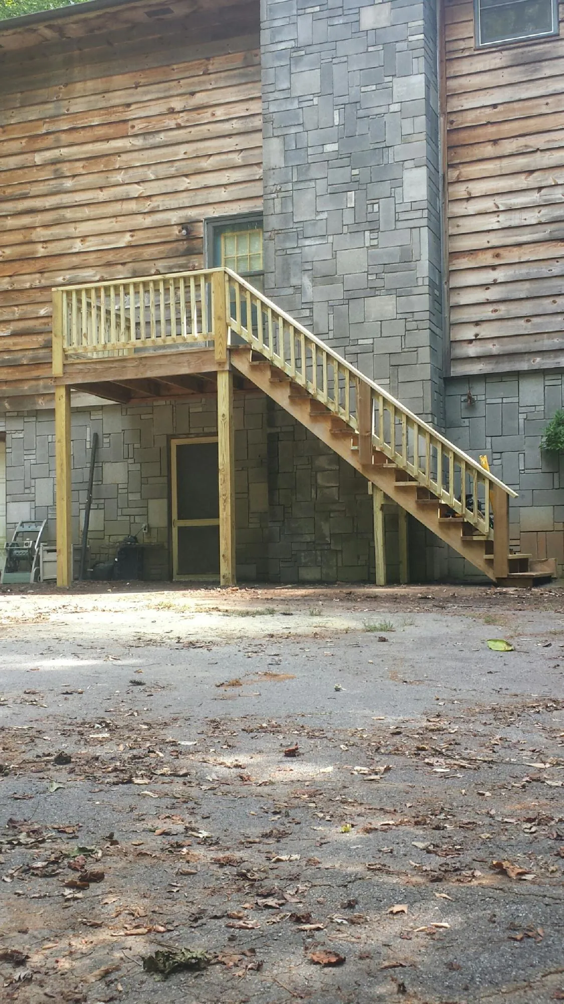 New pressure treated deck and stair landing on a log home in Green Village